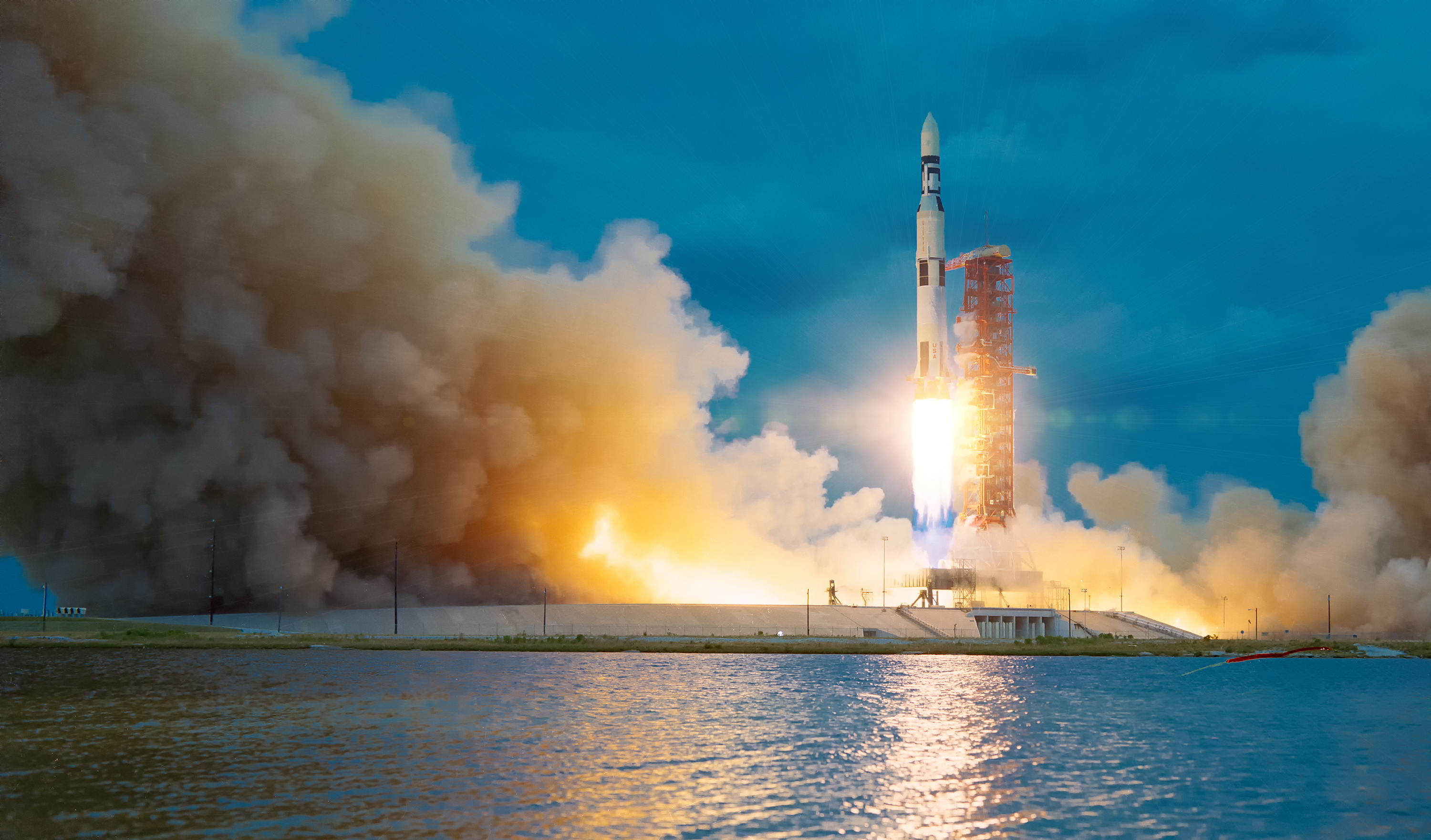 Rocket launching with fiery exhaust against blue sky